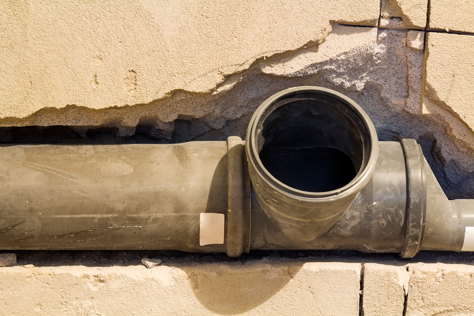 Installation of sewer pipes in a bathroom of an apartment interior during renovation works. Gray